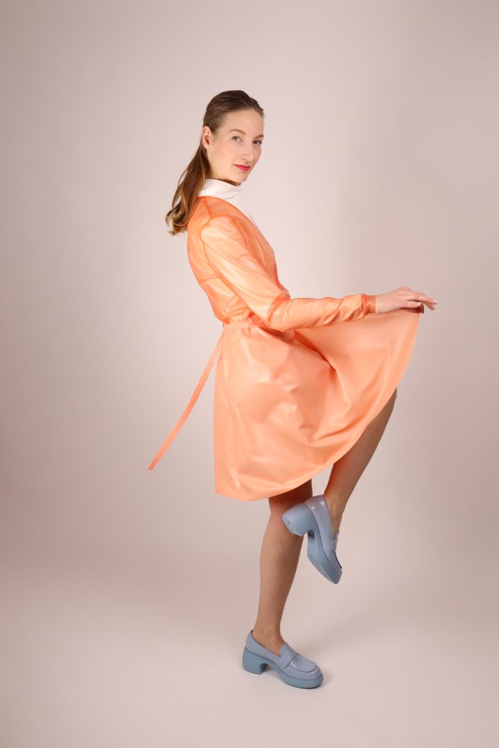model-striking-a-pose-in-pale-coral-latex-wrap-dress-by-tarza-and-jane-latex