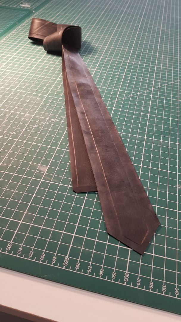 black-latex-narrow-necktie-on-cutting-mat